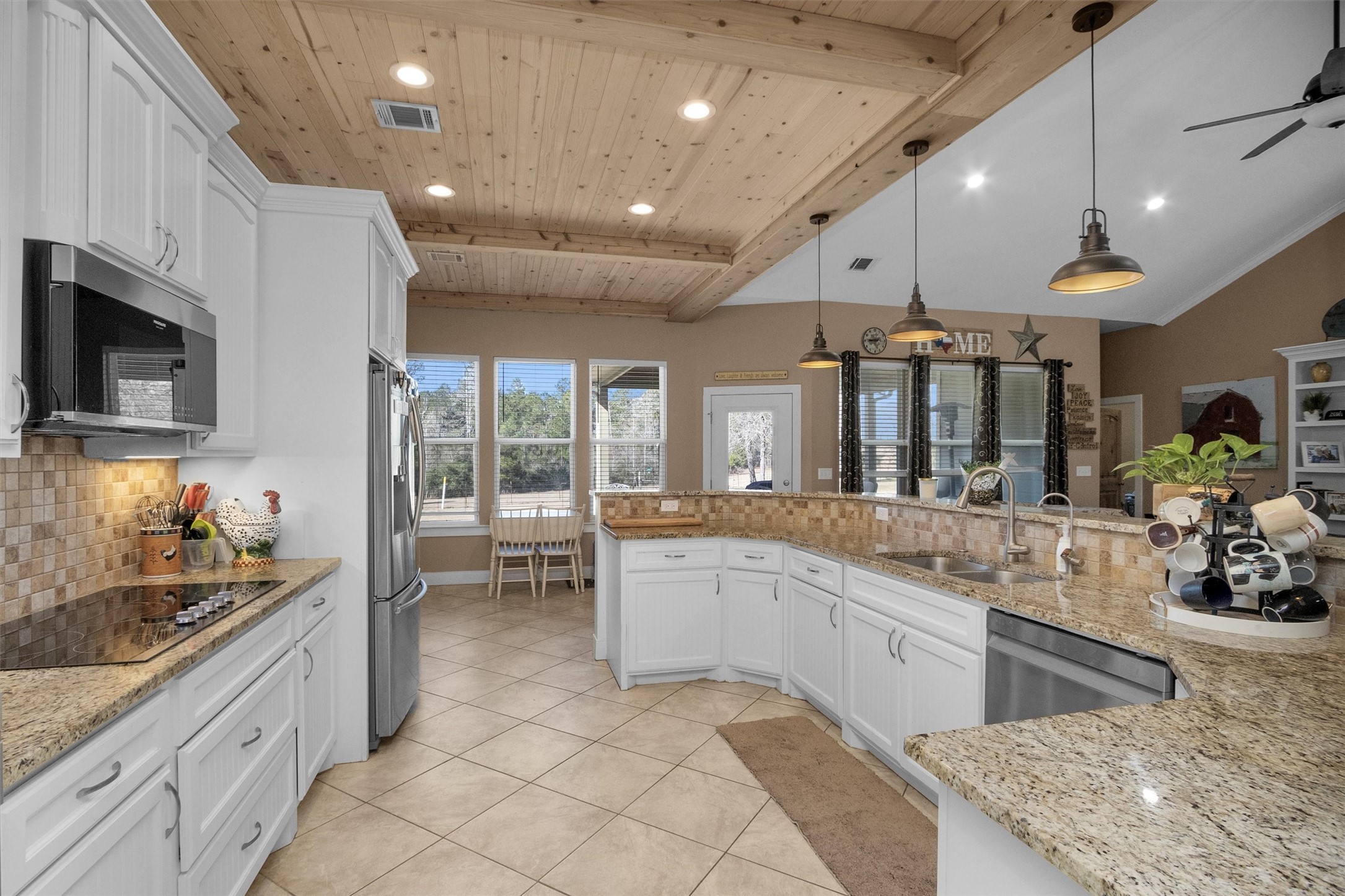12225 High Fire Road Montgomery, TX 77356 - Photo 17 of 45 a large white kitchen with a large window and stainless steel appliances