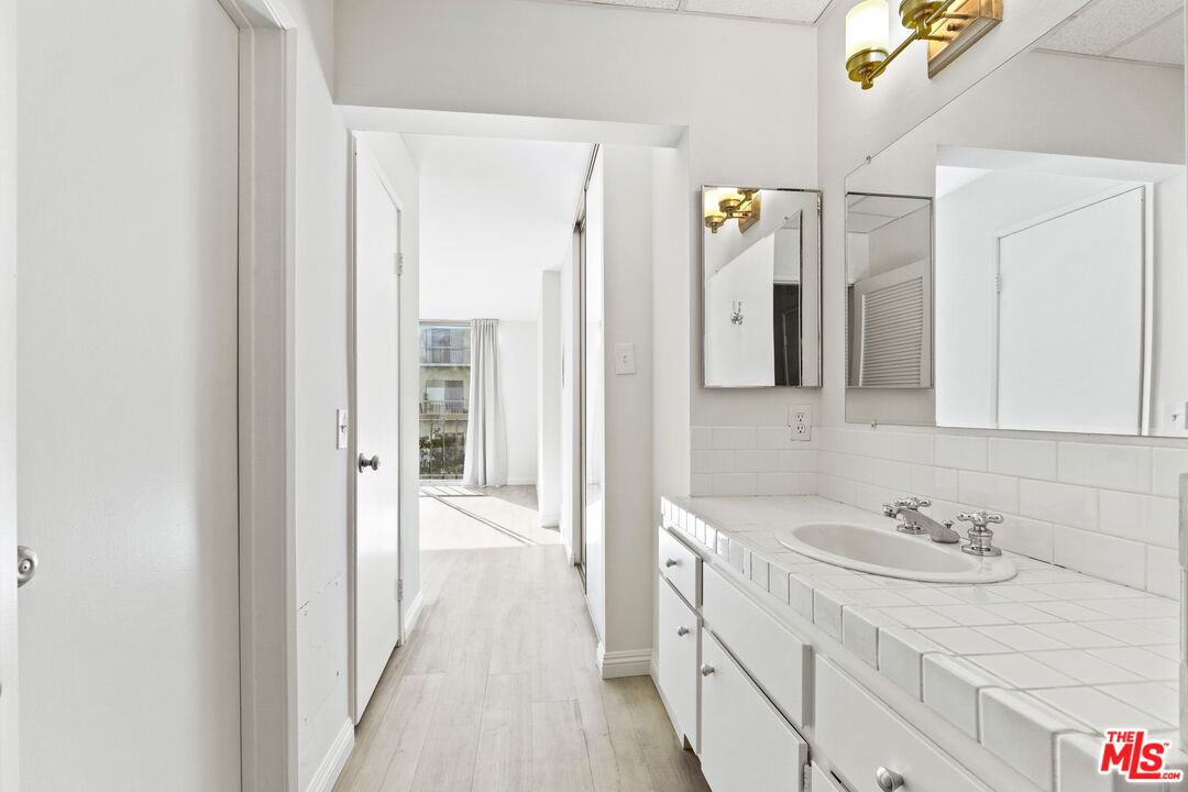 10747 Wilshire Boulevard, Unit 703 Los Angeles, CA 90024 - Photo 11 of 16 a bathroom with a sink and a mirror