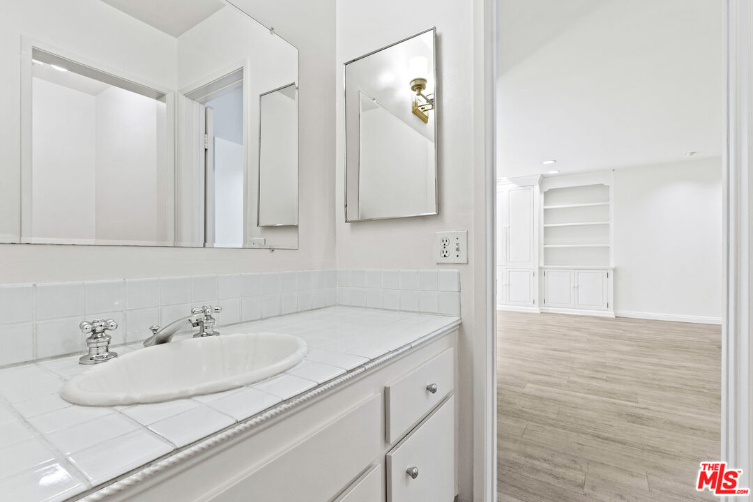 10747 Wilshire Boulevard, Unit 703 Los Angeles, CA 90024 - Photo 14 of 16 a bathroom with a sink and a mirror