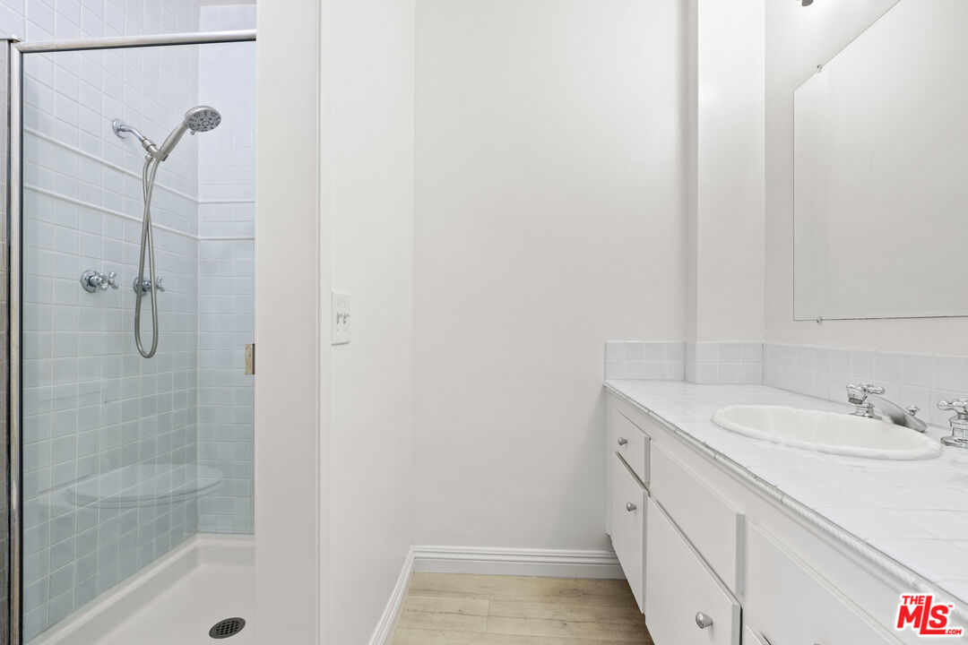 10747 Wilshire Boulevard, Unit 703 Los Angeles, CA 90024 - Photo 15 of 16 a bathroom with a shower and vanity