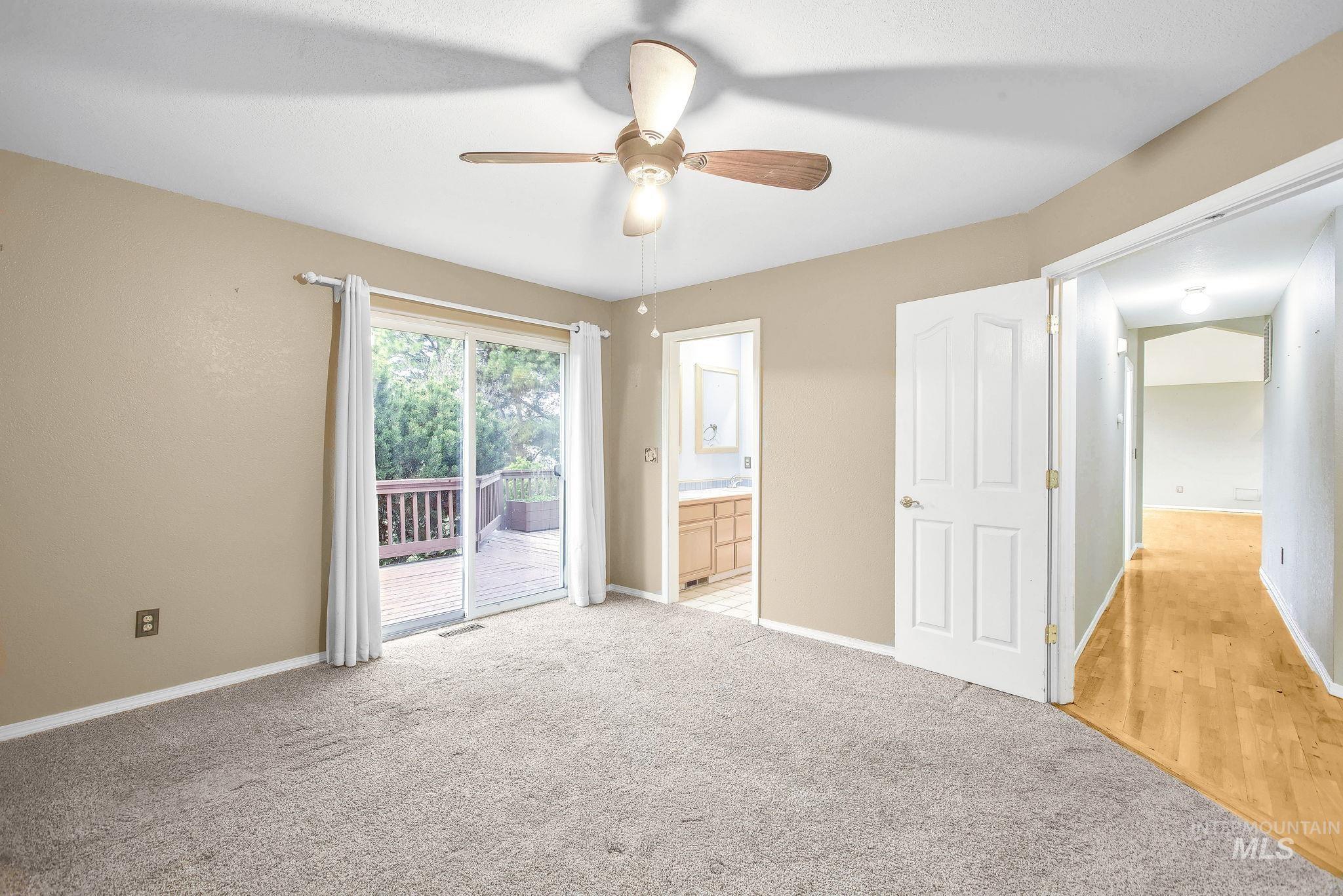 2242 Chukar Lane Clarkston, WA 99403 - Photo 19 of 41 Unfurnished bedroom with access to exterior, ensuite bath, carpet, and a ceiling fan