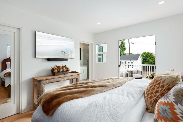 a bedroom with a bed and a flat screen tv