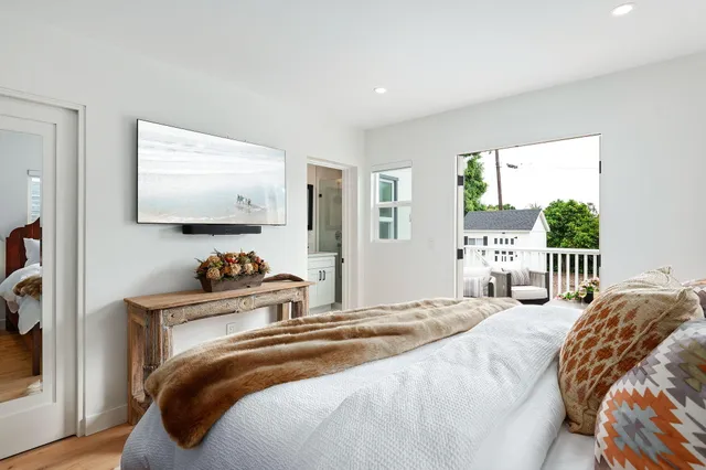 a bedroom with a bed and a flat screen tv