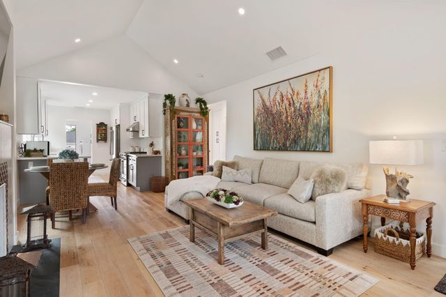 a living room with furniture and a painting on the wall