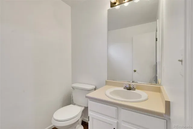 a bathroom with a sink toilet and a mirror