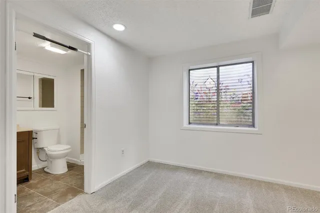 a bathroom with a toilet sink and a vanity