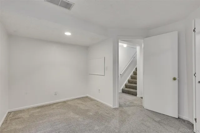 a view of an empty room with stairs