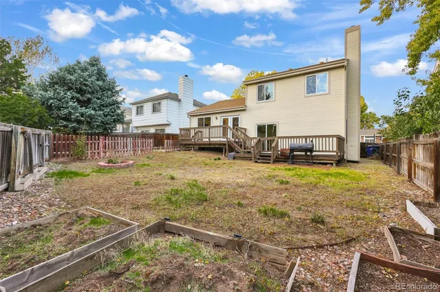 a backyard of a house with table and chairs
