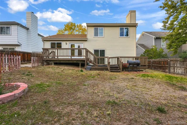 a view of a house with wooden fence