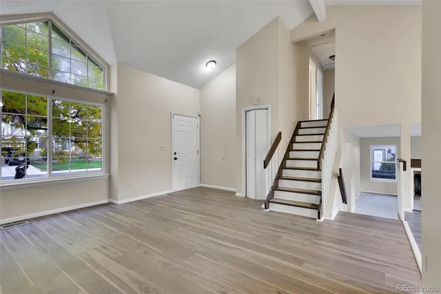 a view of entryway and hall with wooden floor