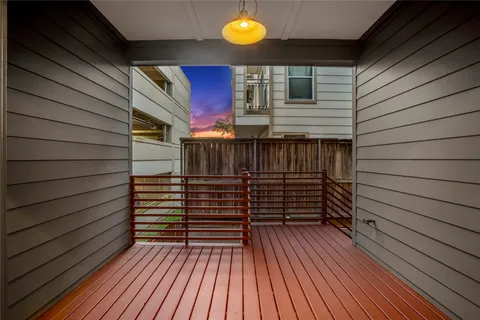 a view of outdoor space with wooden floor and windows