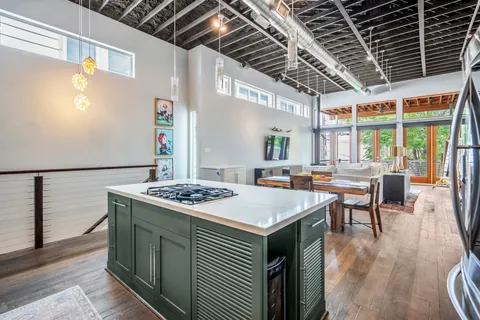 a kitchen with refrigerator and wooden cabinets