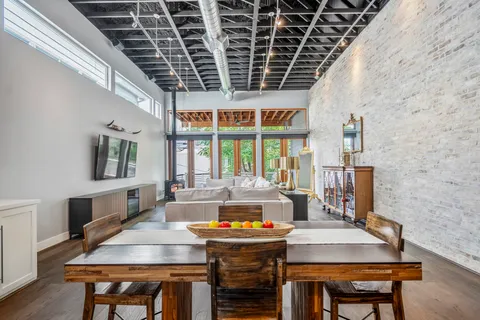 a dining room with furniture a rug and wooden floor