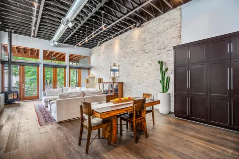 a living room with furniture and a floor to ceiling window