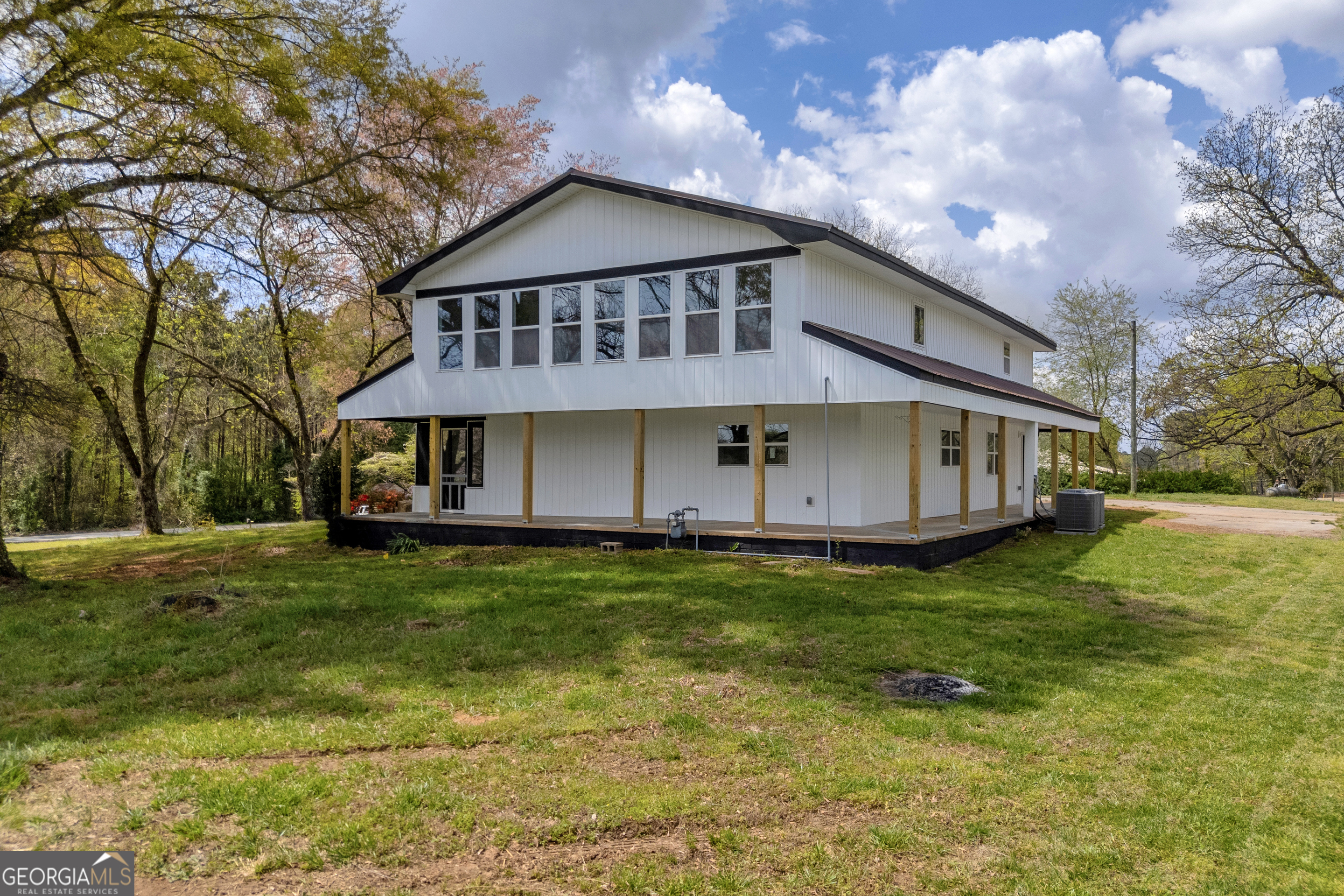 a view of a house with a yard porch and sitting area