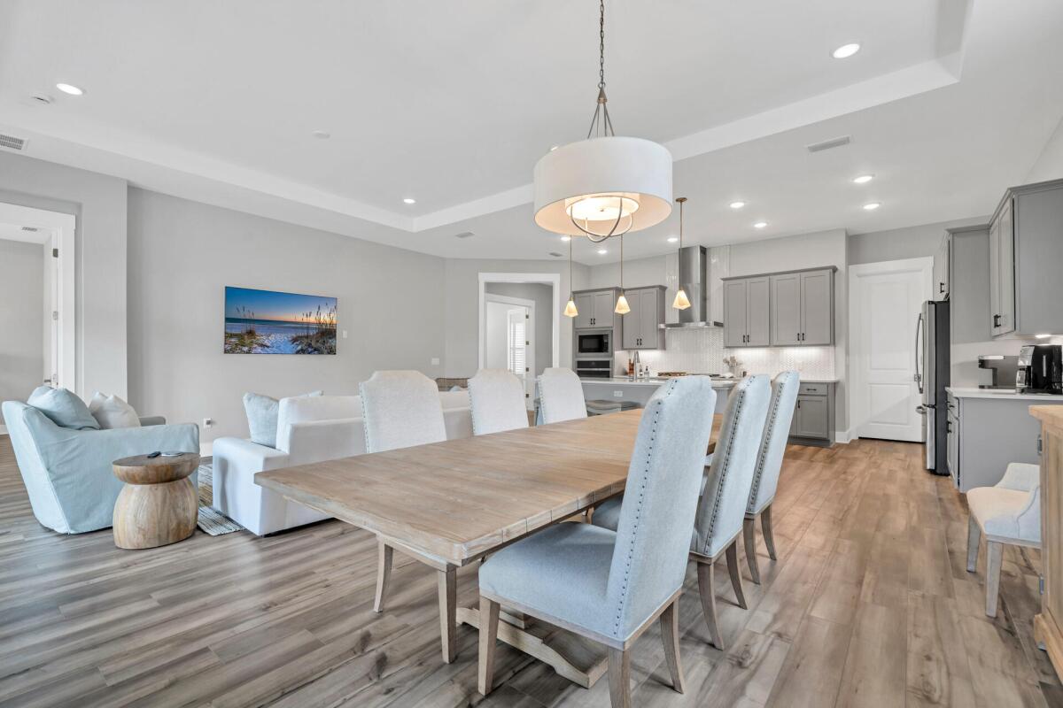 117 River Rise Way Inlet Beach Inlet Beach, FL 32461 - Photo 3 of 12 a view of a dining room with furniture a kitchen and chandelier