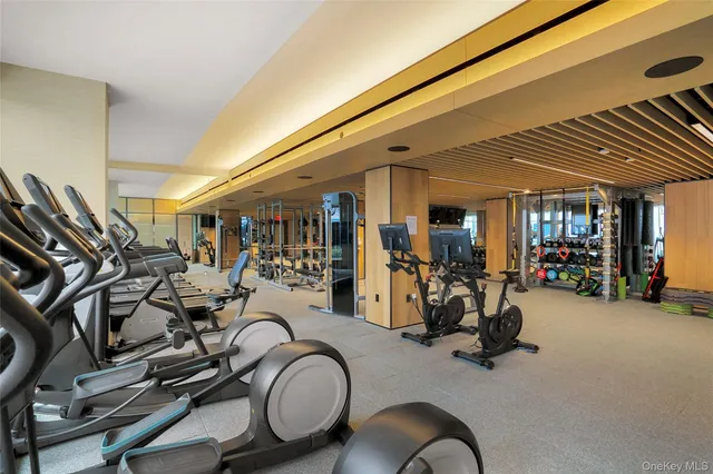 a play room with furniture and a floor to ceiling window