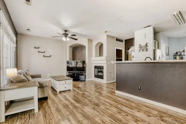 a living room with furniture and a fireplace