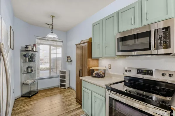 a kitchen with stainless steel appliances granite countertop a stove and cabinets