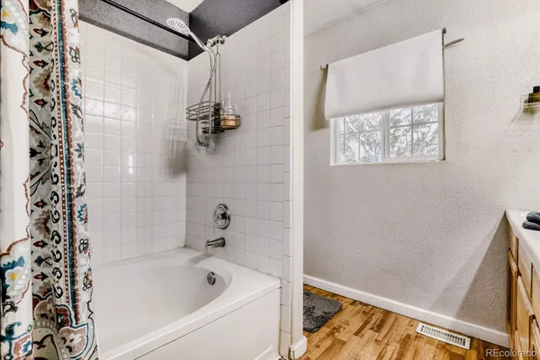 a bathroom with a bathtub and shower
