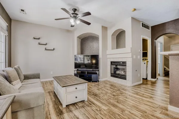 a living room with furniture and a fireplace