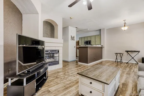 a kitchen with stainless steel appliances kitchen island granite countertop a stove and a sink