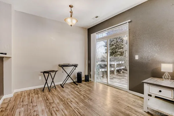 a view of a livingroom with wooden floor and a window