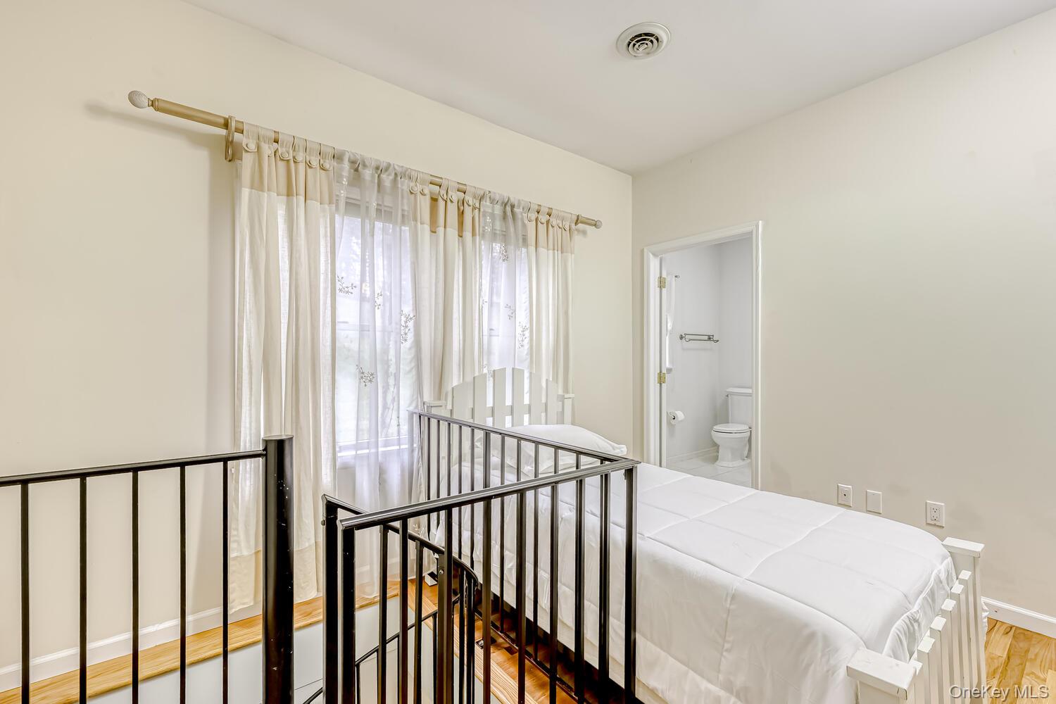 22 Golden Road Suffern, NY 10901 - Photo 20 of 41 Bedroom with light wood-style flooring and connected bathroom