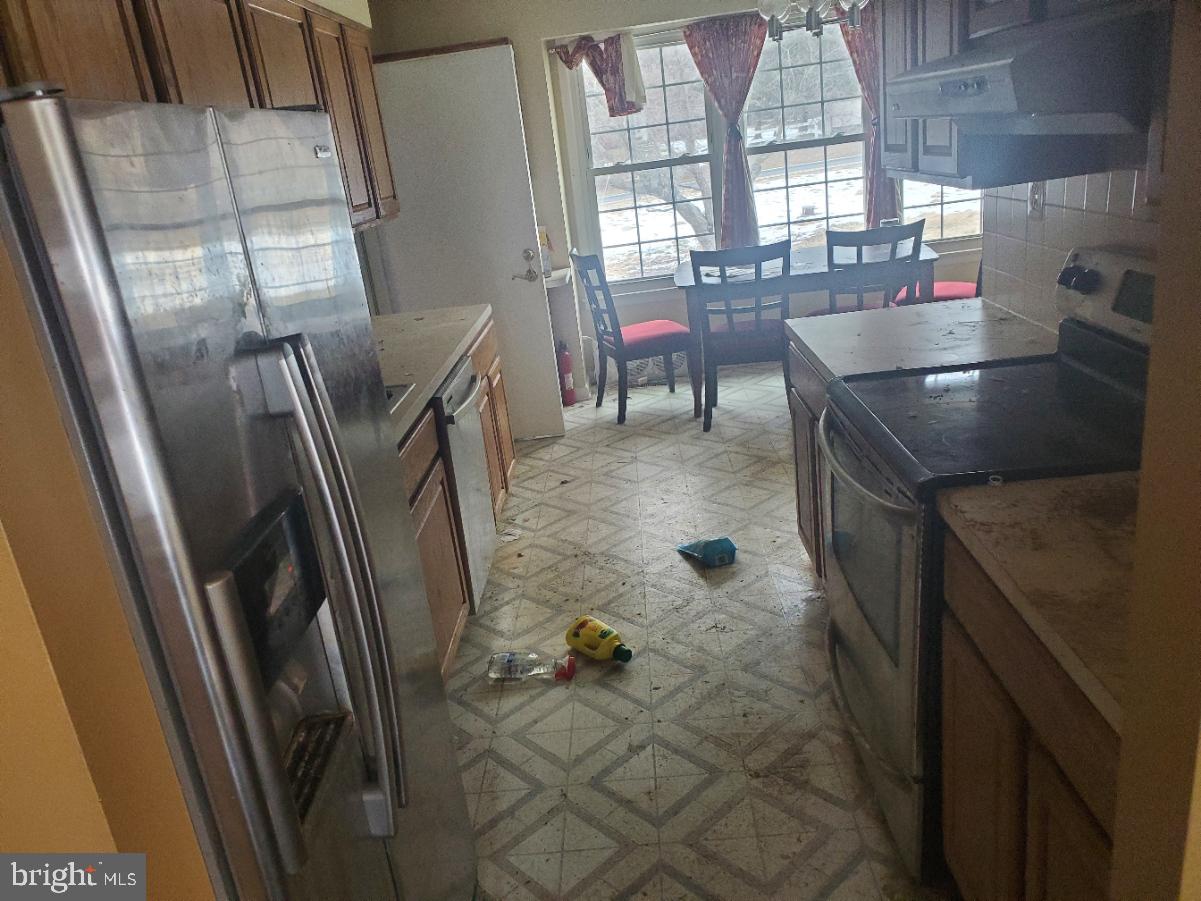 12408 West Old Baltimore Road Boyds, MD 20841 - Photo 3 of 13 a kitchen with refrigerator and window