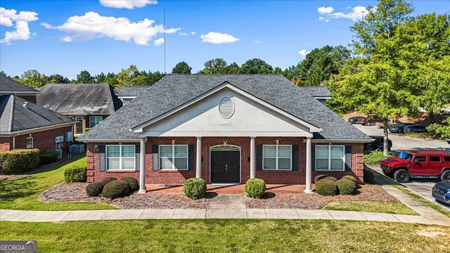 a view of house with yard outdoor seating and swimming pool