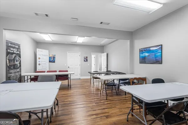 a view of a dining room with furniture and wooden floor