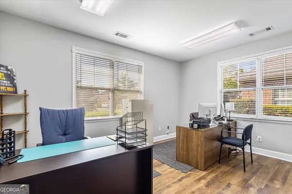 a living room with furniture and large windows