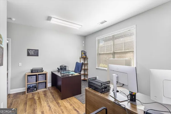 a view of a workspace with furniture and a window