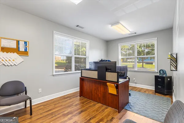 a view of a livingroom with workspace and a window