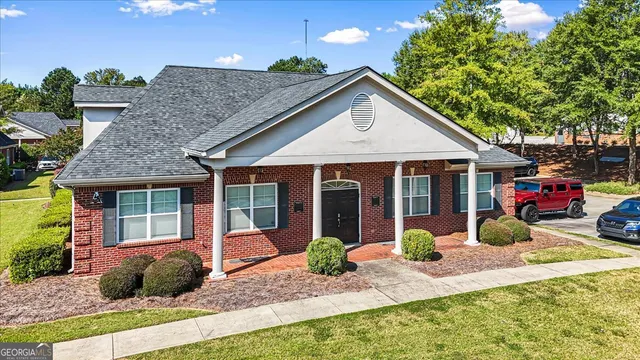 a front view of a house with garden