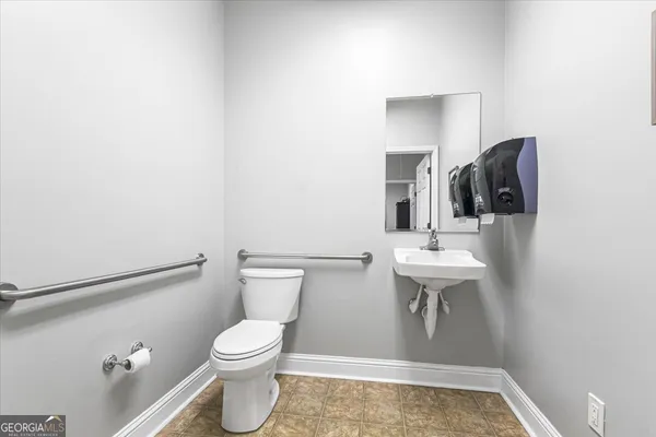 a white toilet sitting next to a bathroom sink