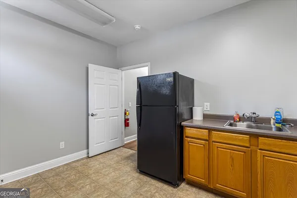 a kitchen with a refrigerator and a sink
