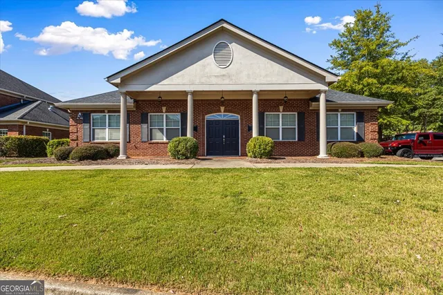 a front view of a house with garden