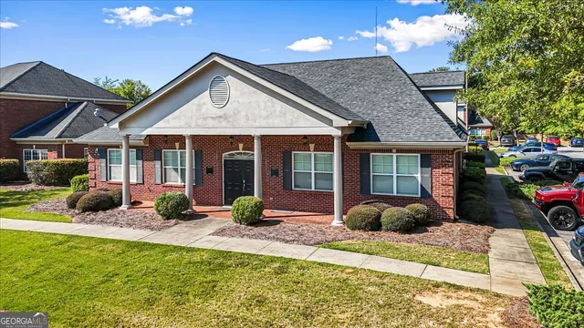 a front view of a house with a porch and furniture