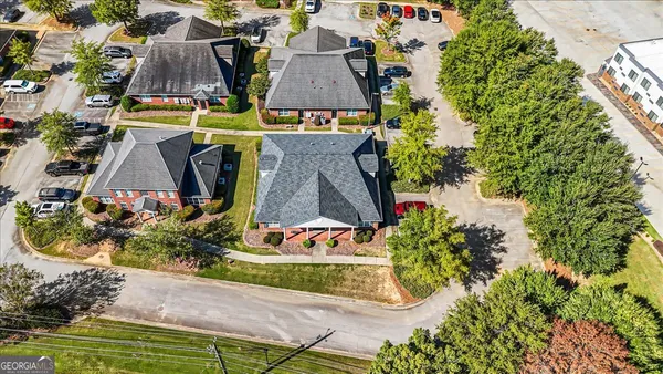 an aerial view of residential houses with outdoor space