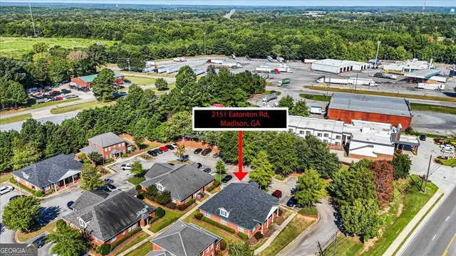 an aerial view of a house with a garden and lake view