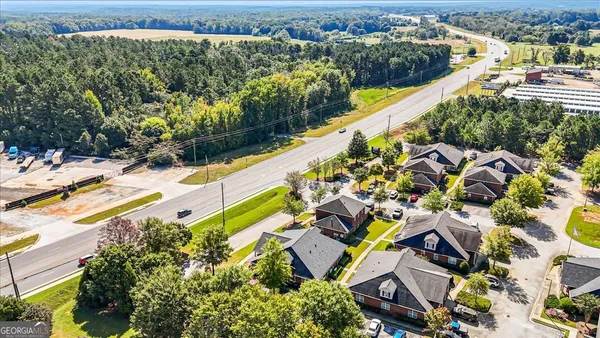 an aerial view of a house with a yard and lake view