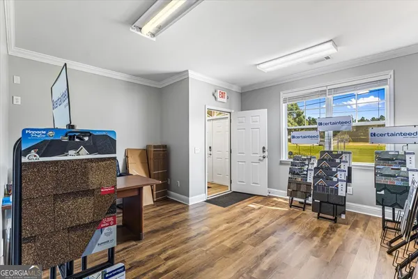 a living room with furniture and a floor to ceiling window