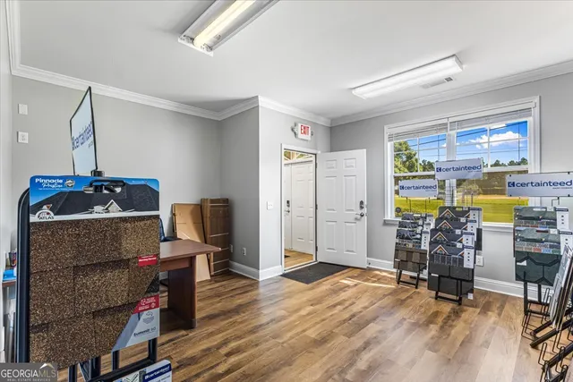a living room with furniture and a floor to ceiling window