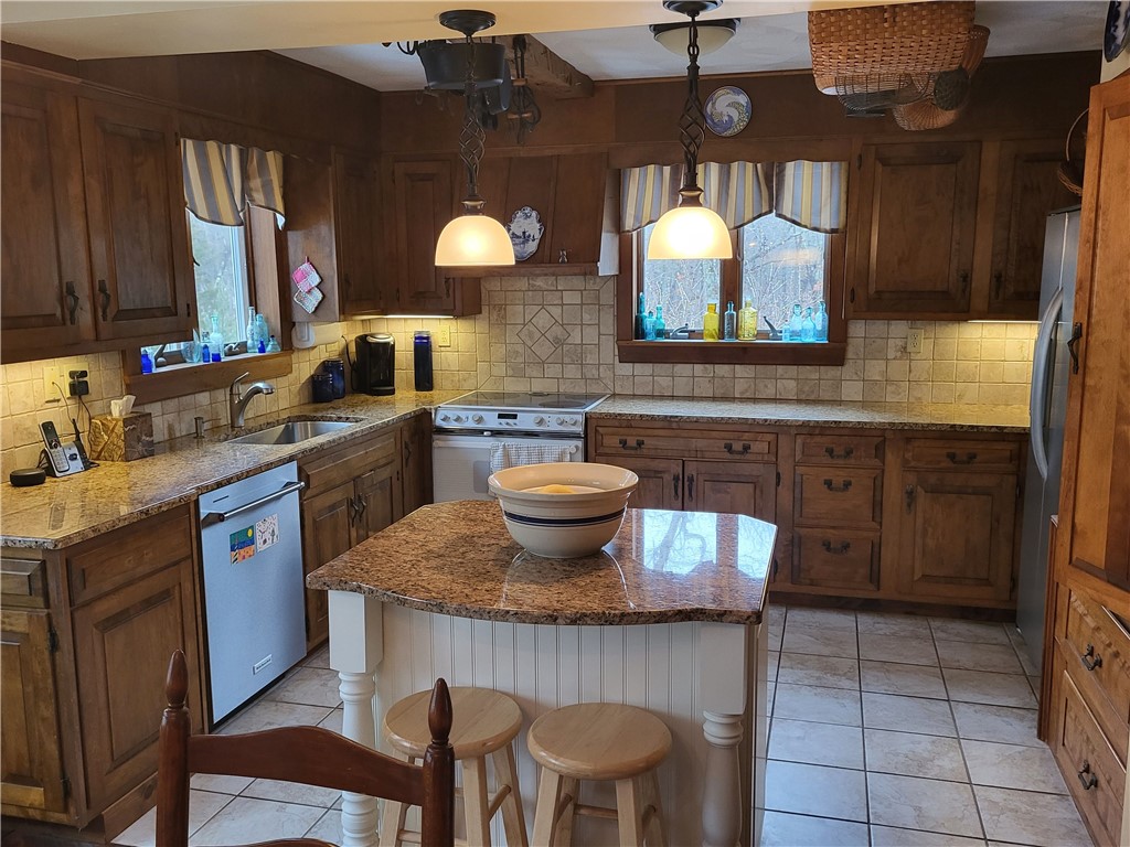 276 Widow Sweets Road Exeter, RI 02822 - Photo 7 of 44 Granite counter w/center island & pantry, tumble marble backsplash, open to dining area & family room