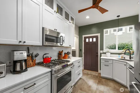 a kitchen with a refrigerator and a sink