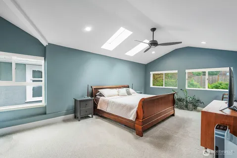 a bedroom with a bed desk and a window
