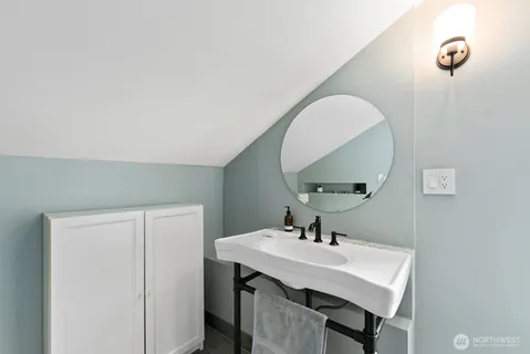 a en suite bathroom with a granite countertop sink and a mirror