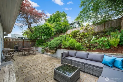 a view of backyard with seating and green space