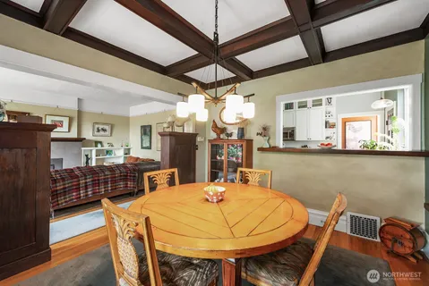 a dining table with chairs and window